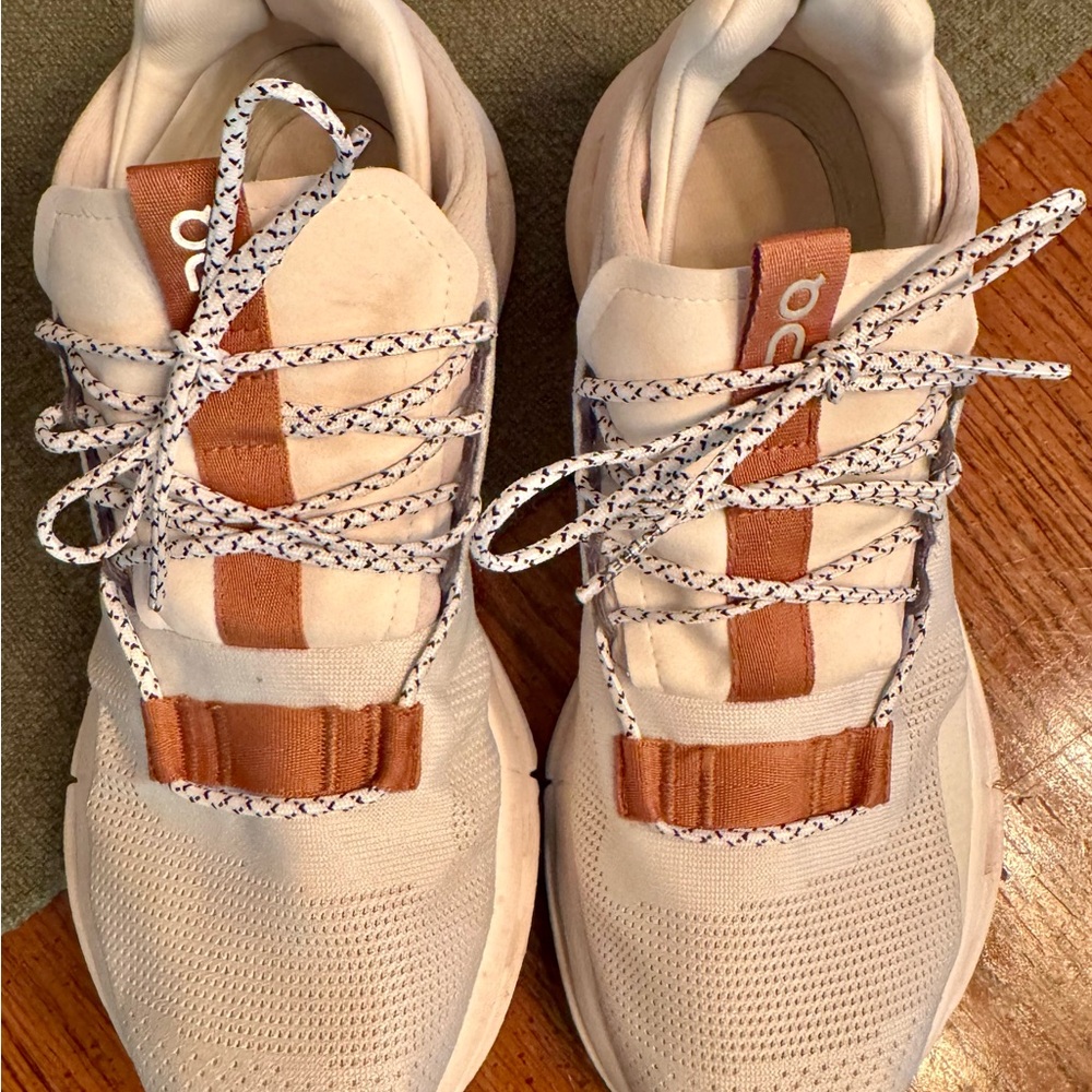 On Running White and Tan Athletic Shoes